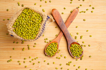 Fototapeta na wymiar Green gram or mung bean in wooden spoon over wooden background.