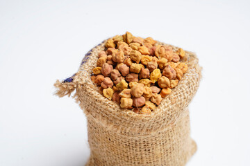 Dry chickpea in bag over white background.