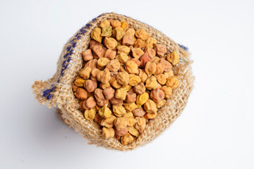 Dry chickpea in bag over white background.
