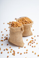 Dry chickpea in bag over white background.