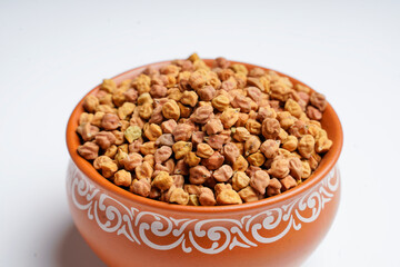 Dry chickpea in bowl on white background.