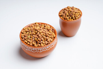 Dry chickpea in bowl on white background.