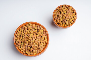 Dry chickpea in bowl on white background.