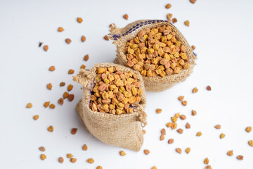 Dry chickpea in bag over white background.