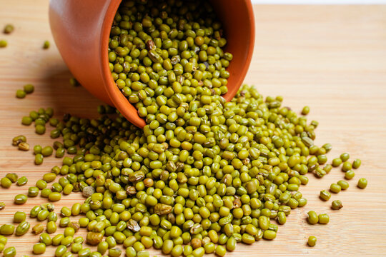 Green gram or mung bean in bowl over wooden background.