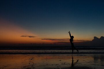 beautiful girl dancing at sunset.
