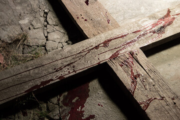 Blood drips on a wooden cross