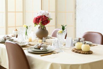 Beautiful table setting for wedding celebration with candles in restaurant