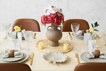Beautiful table setting for wedding celebration with burning candles in restaurant