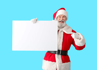 Santa Claus with blank poster on color background