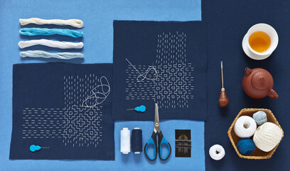 Top view of two hand-made Sashiko embroidery in Japanese style, different types of threads, blue...