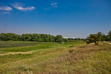 river on the plain against the blue sky