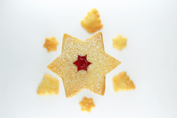 Linzer cookie in a shape of star filled with strawberry jam