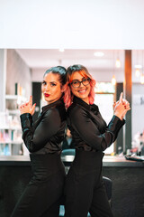Portrait of two young adult woman hairdresser stylish at salon with copy space
