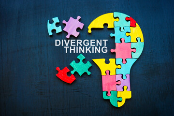 Divergent thinking sign and bulb from puzzle pieces.