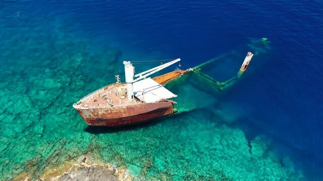 Aerial drone video of famous shipwreck of "Nordland" half sunk ship in islet of Prasonisi near Diakofti main port of Kithira island, Ionian, Greece