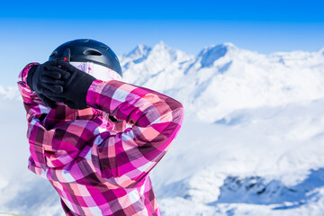 Happy girl snowboarder posing in sunglasses