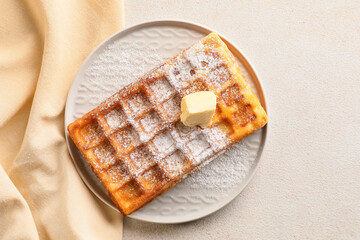 Delicious Belgian waffle with butter in plate on white background