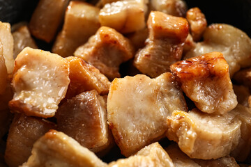 Tasty cracklings in frying pan, closeup