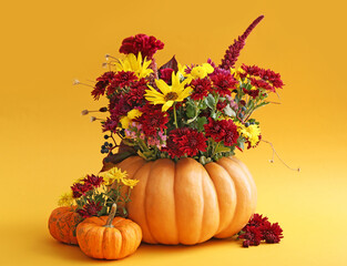 Beautiful autumn bouquet with pumpkins on color background