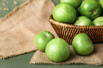 Fresh green tomatoes on table