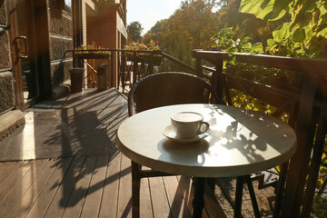 Cup of tasty coffee on table in outdoor cafe