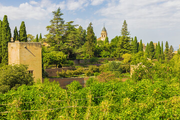 Naklejka premium View of the northern walls of the Alhambra, seen from the lower gardens on the way to the Generalife