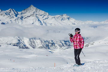 Happy skier girl posing in sunglasses