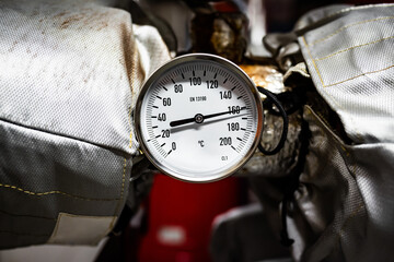 Barometers on pressure pipes, technical room with heat and water distribution