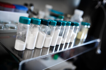 Glass closable test tubes filled with solid powder chemical, chemical laboratory environment