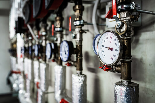 Barometers on pressure pipes, technical room with heat and water distribution