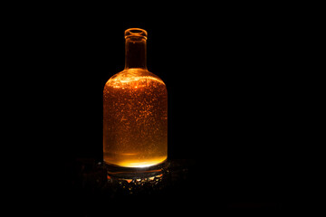 dark brown liquid bottle with refraction and highlights on dark background