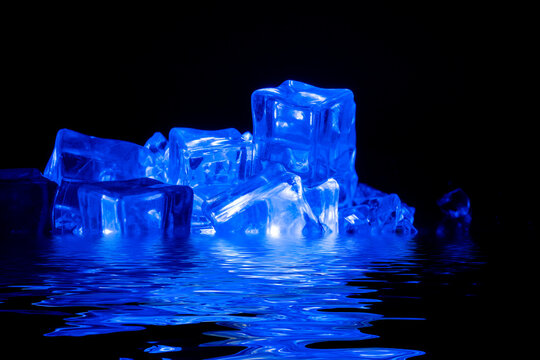Ice cubes filling with smoke on a dark background