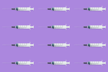 Seamless pattern with medical syringe and needle on purple background