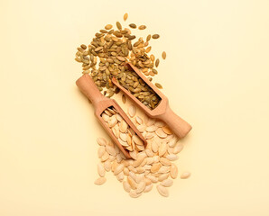 Scoops with natural pumpkin seeds on yellow background © Pixel-Shot
