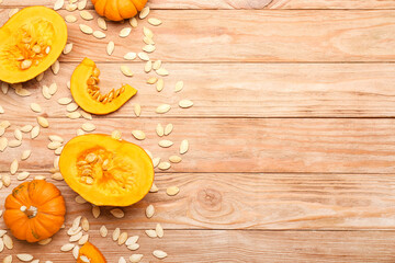 Natural pumpkin seeds and fresh vegetables on wooden background