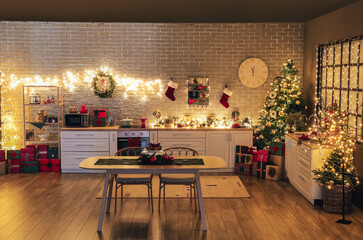 Interior of kitchen with Christmas tree, gift boxes, decor and dining table