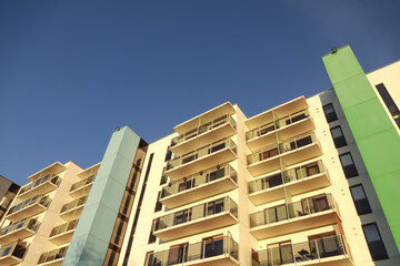 White modern apartments building facade in sunlight on a sunny day with clear blue sky. Vana - Kuuli street.
