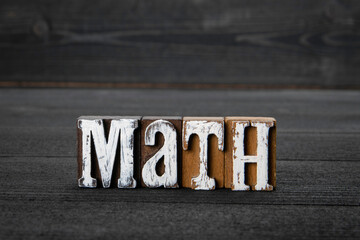 Math. Education, skills and science and physics concept. Word on a wooden background
