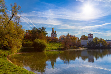View of the Novodevichy convent (Bogoroditse-Smolensky monastery) and the big Novodevichy pond on a sunny autumn day. Moscow, Russia. UNESCO world heritage site