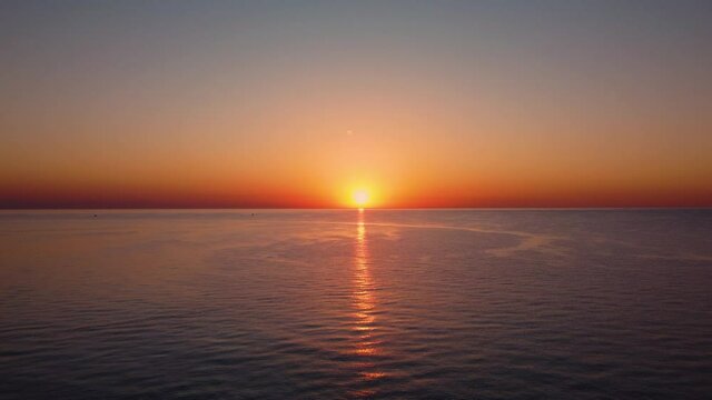 Beautiful sunrise over the sea. Flying upward relative to the horizon