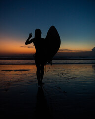beautiful girl with a surfboard at sunset.