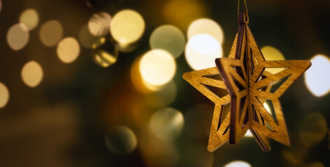 Close up christmas vintage wooden star shaped bauble on defocus background, copy space