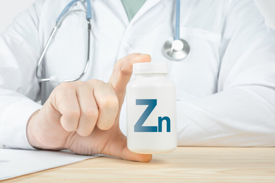 Essential supplement Zinc Zn for human. doctor recommends taking Zinc. doctor talks about Benefits of Zn. Zinc - Health Concept. blue background, copy space
