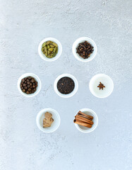 Obraz na płótnie Canvas Ingredients for Indian masala tea on gray background. High quality photo