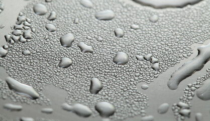 Fototapeta na wymiar Macro background with water droplets condensation pattern on metal surface 