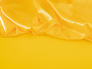 Creative modern Christmas composition with illuminating yellow table against shiny golden curtain....
