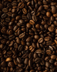 Roasted coffee beans. Top view on golden, aromatic beans. Natural background.