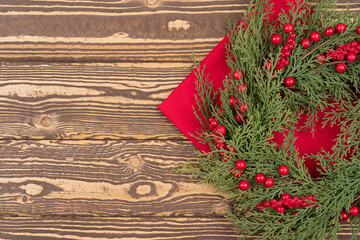Christmas wreath on red napkin, served wooden table from Christmas celebrate background, with copy space for text