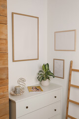 Blank frame hanging on light wall indoors. Space for design